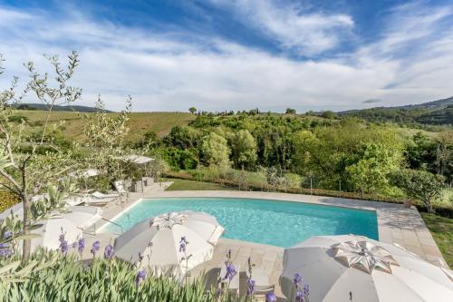 an image of a swimming pool in a garden with purple flowers at Casale Le Masse in Greve in Chianti