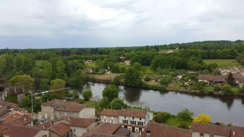 an aerial view of a town with a river at Vingt Grand Rue in Champagne-Mouton