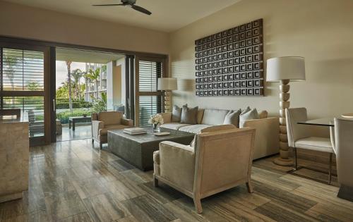 a living room with a couch and a table at Four Seasons Resort and Residences Anguilla in Meads Bay