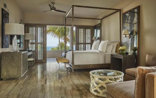 a bedroom with a bed and a living room at Four Seasons Resort and Residences Anguilla in Meads Bay