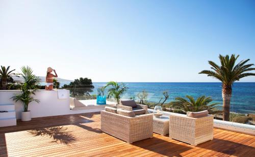 a living room with a view of the ocean at Gecko Hotel & Beach Club in Playa Migjorn