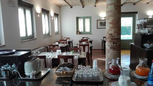 a dining room with tables and chairs and windows at Hotel San Claudio in Corridonia