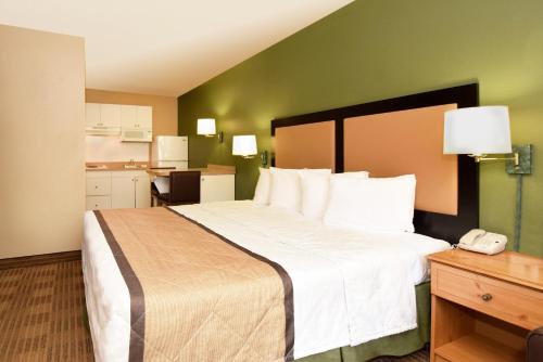 a hotel room with a large bed and a phone at Extended Stay America Suites - San Jose - Sunnyvale in Sunnyvale
