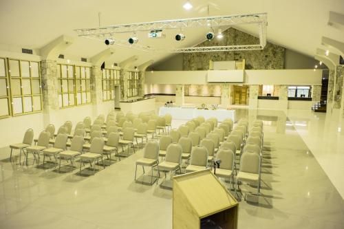a large room with chairs and a podium in it at Africanos Country Estate in Addo