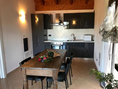 eine Küche mit einem Holztisch und einigen Stühlen in der Unterkunft Il Gerlo in Lezzeno