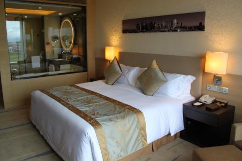 a hotel room with a large bed and a phone at Crowne Plaza Guangzhou Huadu by IHG - Free Shuttle bus between hotel to Exhibition Center During Canton Fair in Guangzhou
