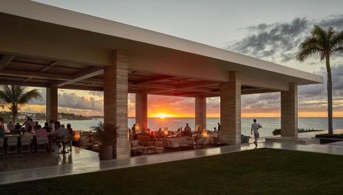 a rendering of a restaurant with a sunset in the background at Four Seasons Resort and Residences Anguilla in Meads Bay