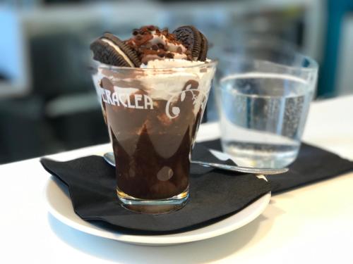 a cup of chocolate milkshake on a plate with cookies at DubaiVillage in Camposano