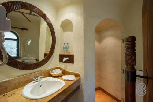 a bathroom with a sink and a mirror at Serengeti Serena Safari Lodge in Serengeti National Park