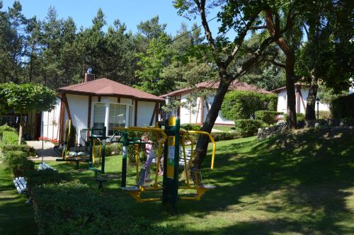 a playground in the yard of a house at Ameba Resort in Mielno