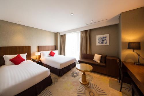 Postel nebo postele na pokoji v ubytování Solaria Nishitetsu Hotel Busan