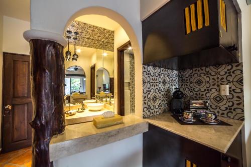 a bathroom with a sink and a large mirror at Hotel Riviera Del Sol in Playa del Carmen