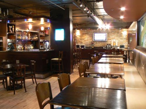 a restaurant with tables and chairs and a bar at Banff Inn in Banff