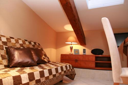 a attic bedroom with a bed and a lamp at Cannes Loft Alexander in Cannes