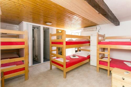 a room with four bunk beds in a house at The City Place Hostel in Dubrovnik