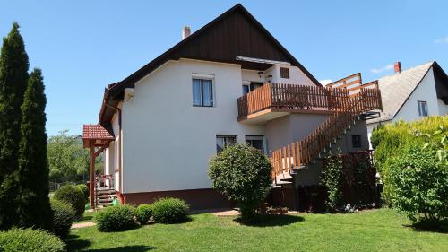a house with a staircase and a yard at Magyar Apartmanházak I-III. in Zalakaros
