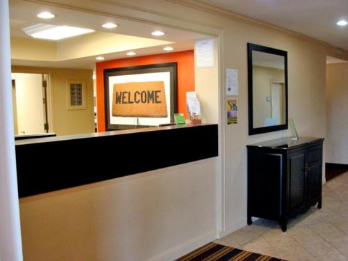 a welcome counter in a lobby with a welcome sign at Extended Stay America Suites - Meadowlands - East Rutherford in East Rutherford