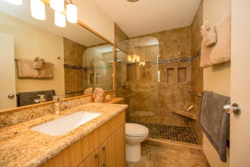 a bathroom with a sink and a shower at Beautiful 2 Bedroom Condo with Panoramic Ocean Views | Oceanfront in Kihei