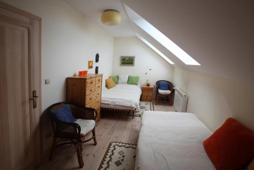 a attic room with two beds and a desk and a room with a bedsenal at Mieszkanie Pod Dobrym Aniołem in Czempiń