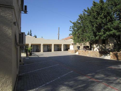 an empty parking lot in front of a building at Clanwilliam Hotel in Clanwilliam