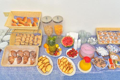 a table with baskets of different types of food at Charme Hotel La Villa Tina in Ischia