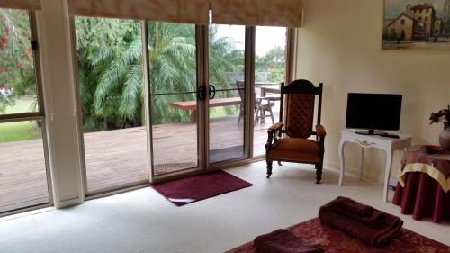 a living room with a sliding glass door to a deck at Hilltop Hideaway in Ninderry