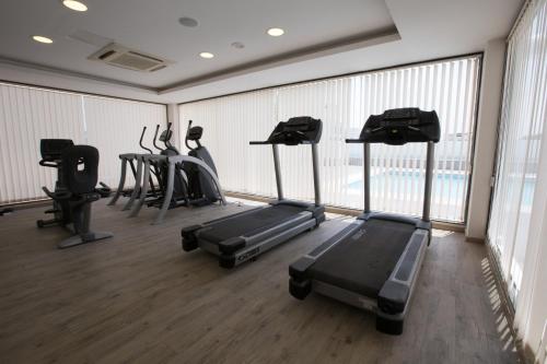 a gym with treadmills and elliptical machines at M Inn in Coimbatore