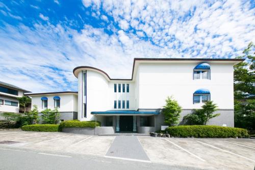 a white building with a blue sky at Sundance Resort Hakone Gora in Hakone