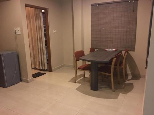 a dining room with a table and chairs at Hotel Pooja International in Dāvangere