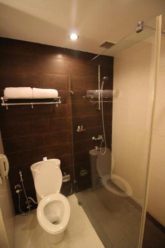 a bathroom with a toilet and a shower at Fortune Select JP Cosmos, Bengaluru - Member ITC Hotels' Group in Bengaluru