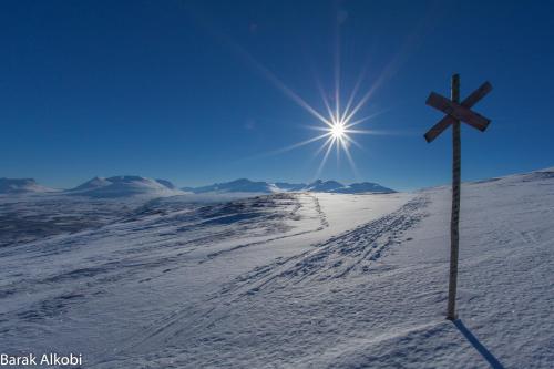 a cross on top of a snow covered slope at Abisko Guesthouse & Activities in Abisko