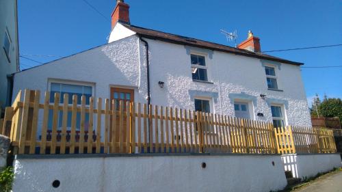 a white house with a wooden fence at Brynawel in Saint Dogmaels