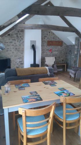 a wooden table and chairs in a living room at Brynawel in Saint Dogmaels
