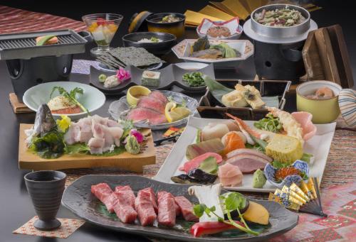 a table topped with lots of different types of food at Nakamurakan in Takayama