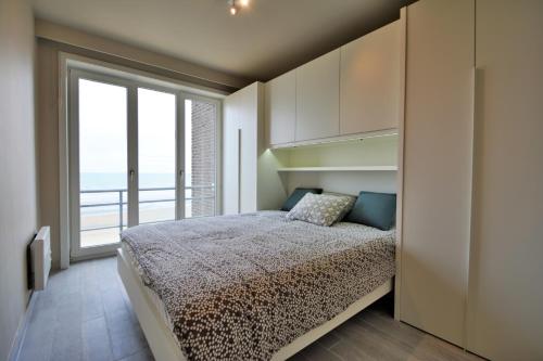 ニーウポールトにあるResidentie Scorpio B1のベッドルーム1室(ベッド1台、大きな窓付)