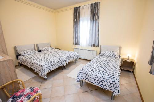 a small room with two beds and a window at Apartment Kampel in Koper