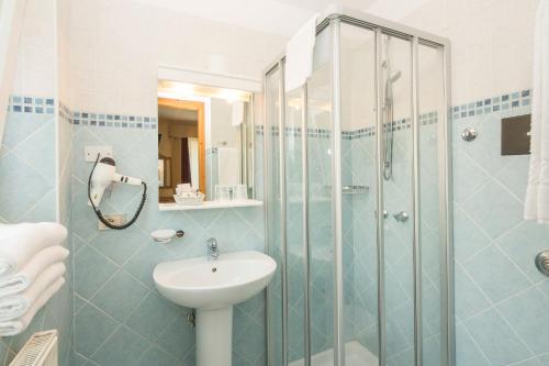 a bathroom with a sink and a shower at Garni Bellavista in Arabba