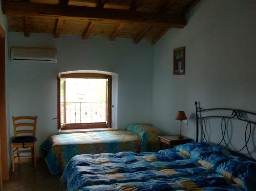 A bed or beds in a room at Agriturismo La Palazzina