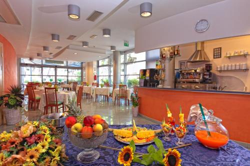 a dining room with a table with fruit on it at Hotel Antares in Alba Adriatica