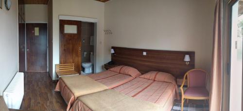 a bedroom with a large bed and two chairs at Edelweiss Hotel in Platres