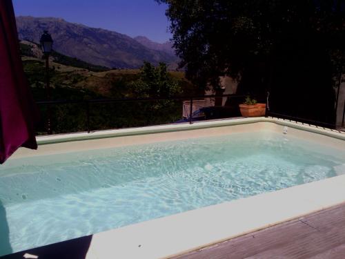 a hot tub with a view of a mountain at Auberge Casa Mathea in Poggio-di-Venaco