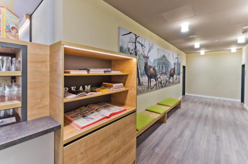 a room with bookshelves and shelves with books at Super 8 Freiburg in Freiburg im Breisgau