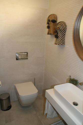 a bathroom with a toilet and a sink at 10 Boutique House in Alcochete