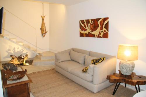 a living room with a couch and a lamp at 10 Boutique House in Alcochete