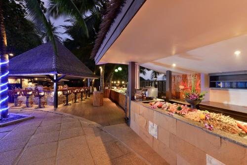 a resort with a bar and a restaurant at Andaman White Beach Resort - SHA Plus in Nai Thon Beach