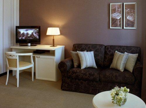 a living room with a couch and a desk at Villa Kristina in Truskavets
