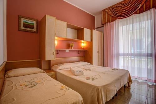 a hospital room with two beds and a window at Hotel Gardenia in Bellaria-Igea Marina