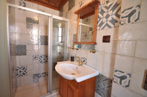 a bathroom with a sink and a shower at Cunda Svila Otel - Adult Only in Ayvalık