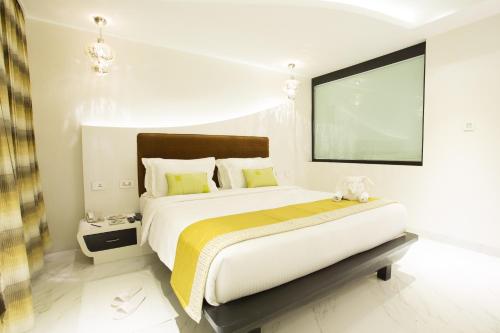 a bedroom with a large bed and a large screen at M Inn in Coimbatore