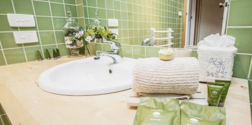 a bathroom counter with a sink and a mirror at Beeches By The Sea in Apollo Bay